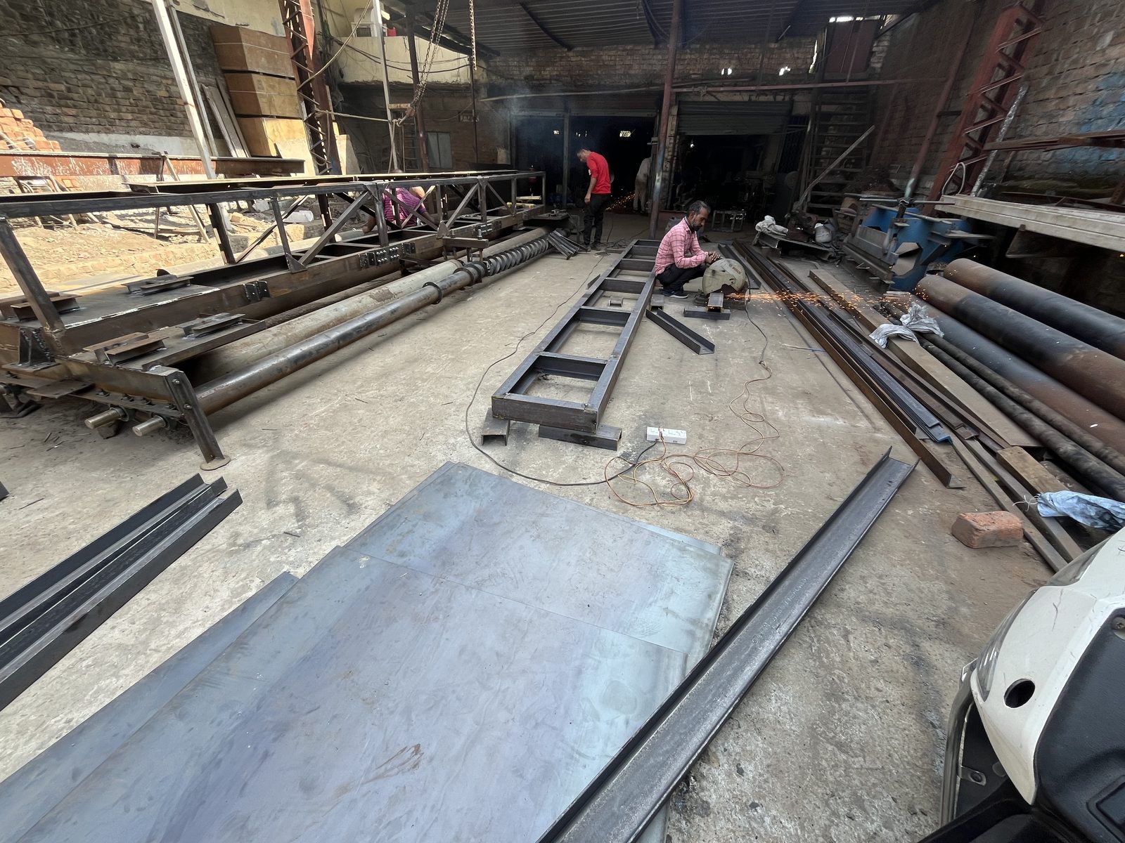 Fixed form concrete paver vibration and screed assembly chassis frame under fabrication