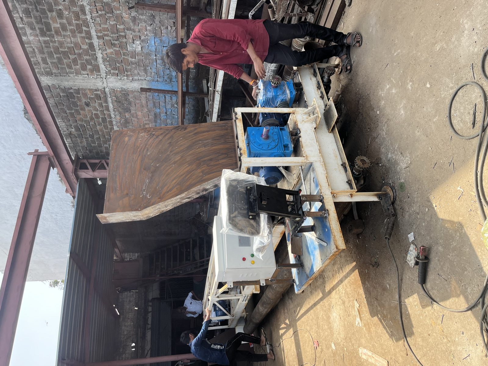 Fixed form concrete paver vibration and screed assembly with control panel and drive motors being fitted